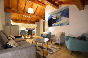 a living room with a couch and chairs and a table at Chalet Barthelemy - 3 Pièces pour 4 Personnes 204 in Saint-Martin-de-Belleville