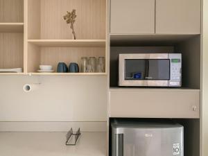 a microwave sitting on top of a kitchen at Comfort One Bed Room Apartment Gold Coast PIK in Jakarta