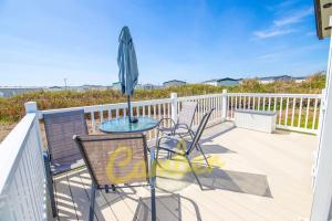 a patio with a table and chairs and an umbrella at MP735 - Parkdean, Camber Sands in Camber
