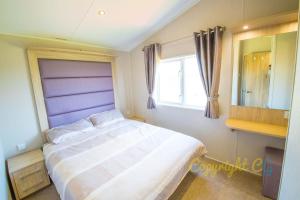 Кровать или кровати в номере SBL54 - Camber Sands Holiday Park - Mini Lodge - 3 Bedrooms - Decking - Dishwasher - Private Parking +32 фотографии