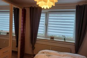 a bedroom with a bed and a window with blinds at Private Rooms in Hannover