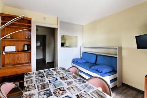 Zimmer mit einem Bett, einem Tisch und Stühlen in der Unterkunft Hyères Parc - maeva Home - Appartement 2 pièces 6 Personnes Confort 14 in Hyères
