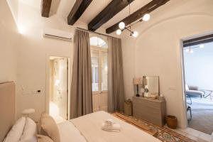 a bedroom with a bed and a large window at Harbour Mansion in Birgu