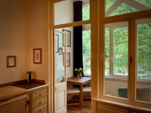a bathroom with a sink and a large window at Mini-Appartements am Burgberg in Bad Harzburg