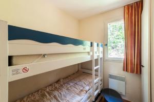 a bedroom with two bunk beds and a window at Les Maisons de Pont Royal en Provence - maeva Home - Maison 4 Pièces 8 Personnes climatisée - Confort MAE-0094 in Mallemort +27 photos