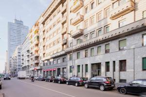 een straat met auto's aan de zijkant van een gebouw bij Central wonderful flat Repubblica Central station in Milaan
