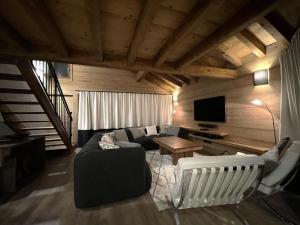 ein Wohnzimmer mit einem Sofa und einem Tisch in der Unterkunft Chalet Des Encombres - Pièces 314 in Saint-Martin-de-Belleville