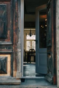 an open door to a dining room with a table at Kalnciema kvartāla Kuldīgas rezidence in Kuldīga