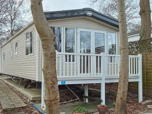 uma pequena casa com um alpendre branco em Hazel Glen 3 - Beauport Park - Hastings em Hastings