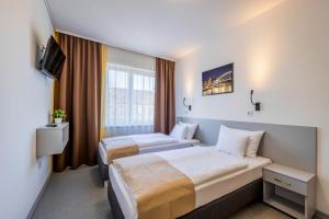 Posteľ alebo postele v izbe v ubytovaní Arrabona Rooms