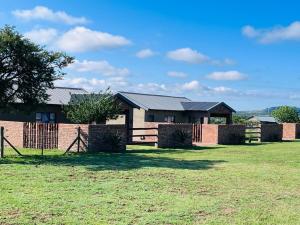 a house in a field with a fence at The Comfy Corner @ Skyfall Country Estate in Polokwane