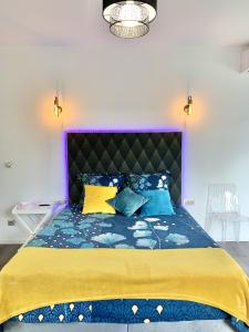a bedroom with a large bed with a purple headboard at Maison avec piscine in Agay - Saint Raphael +43 photos