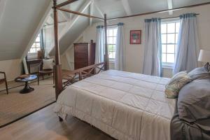 a bedroom with a large bed and a staircase at The Sweet Lime Oasis - A Danish West Indies Suite in Christiansted