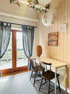 een eetkamer met een tafel en stoelen en een raam bij 5min walk to LEGO House - two bedrooms on Loft floor with Balcony * with garden in Billund