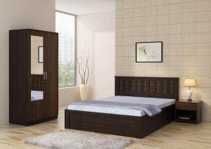 a bedroom with a bed and a cabinet in it at City Plaza in Panchkula