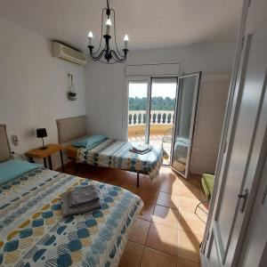 a bedroom with two beds and a balcony at Buena Vista in L'Ametlla de Mar