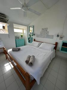 a bedroom with a large bed with towels on it at Casa panoramica Villasimius in Villasimius +51 photos