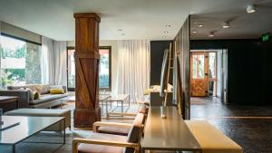 a living room with a couch and a table at Calafate Parque Hotel in El Calafate +40 photos