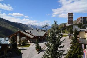 a ski lodge with a mountain in the background at Résidence Lac Du Lou - 2 Pièces pour 4 Personnes 224 in Les Menuires