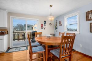 a dining room with a wooden table and chairs at Family Cape Escape—Beach, Boardwalk Game Room in Sandwich