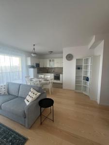 a living room with a couch and a kitchen at WaterFront City Apartments by UrbanRent in Budapest