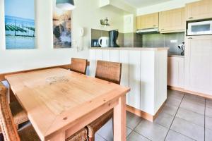 a kitchen with a wooden table and chairs at Résidence Belle Dune - maeva Home - Appartement 2 pièces 4 personnes - Sélection MAE-9334 in Fort-Mahon-Plage +11 photos
