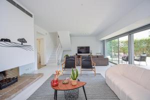 a living room with a couch and a fireplace at Spacious VIlla with Swiming Pool and Terrace in Cascais