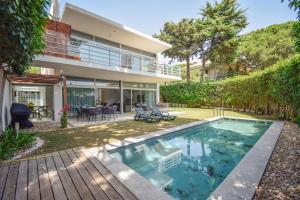 an exterior view of a house with a swimming pool at Spacious VIlla with Swiming Pool and Terrace in Cascais