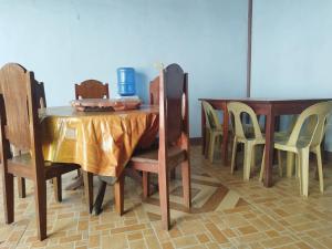 a dining room with a table and chairs and a table and chairsktop at Marian's Transient House in Puerto Princesa City