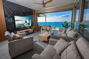 sala de estar con sofá y TV en Shamyam -שמיים- דירות מהממות על חוף הים עם ג'קוזי פרטי ובריכה במתחם en Netanya