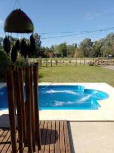 a swimming pool in a yard with a wooden bench at El Destino in San Miguel del Monte +6 photos