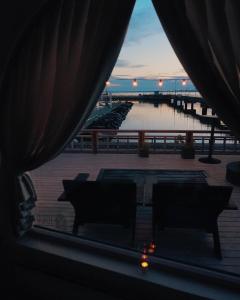 a view from a window of a patio with chairs and a pier at Iglupark in Tallinn