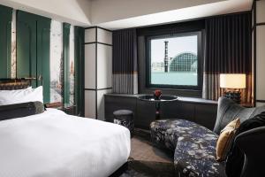 a hotel room with a bed and a window at Hotel Sosei Sapporo MGallery Collection in Sapporo