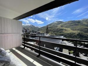 a balcony with a view of the mountains at Résidence Oisans - Studio pour 4 Personnes 514 in Les Menuires