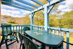 a blue table and chairs on a porch with a view at Résidence Les Belles Rives - maeva Home - Appartement 2 Pièces 5 Personnes - Sélection MAE-2194 in Argentat