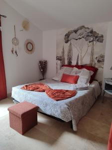 a bedroom with a large bed with red pillows at Chez Monique et Rémi in Avignon