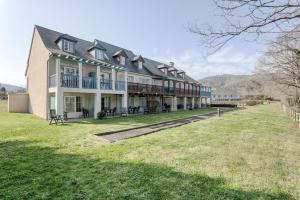 une grande maison avec une pelouse devant dans l'établissement Résidence Les Belles Rives - maeva Home - Appartement 2 pièces 5 personnes - Confort MAE-4334, à Argentat