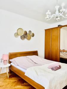 1 dormitorio con 1 cama y reloj en la pared en Serendipity 3, en Pécs