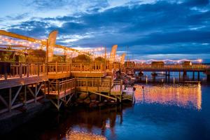 a pier with lights on the water at night at Iglupark in Tallinn