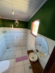 a bathroom with a toilet and a sink and a mirror at Pousada Varanda da Serra in Cavalcante