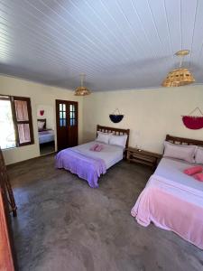 a room with two beds in a room at Pousada Varanda da Serra in Cavalcante
