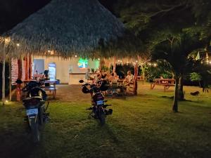 a group of motorcycles parked in a yard at night at Los Chocoyos in Mérida