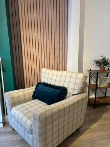 a couch in a living room with a blue pillow on it at Large 3 Bed House - Awsworth - J26 M1 - Ideal for Contractors or Families - Sleeps - 6 