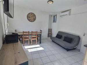 uma sala de estar com um sofá e uma mesa em Appartement plein centre 300m de la plage . em Valras-Plage