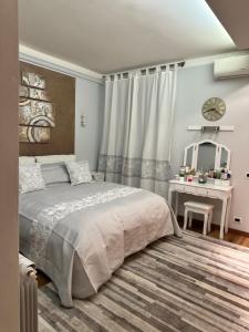 a bedroom with a large bed and a desk at Sergiunca in Bocca di Magra