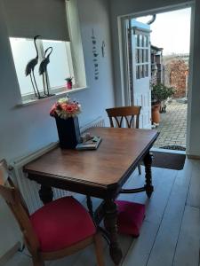 a wooden table in a room with a window at Bed en Boterham in Hedel +12 photos