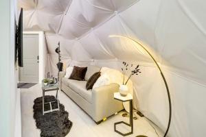 una sala de estar con un sofá blanco en una tienda de campaña en Unique Escapes - Modern Luxury Geodome, en Monticello