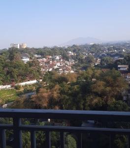 a view of a city from a balcony at Ciumbuleuit Residence, Mountain View Apartment in Bandung