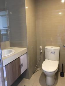 a bathroom with a toilet and a sink at Ciumbuleuit Residence, Mountain View Apartment in Bandung