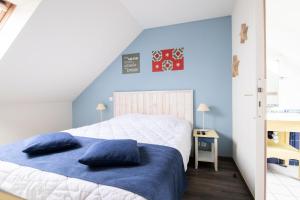 - une chambre avec un grand lit aux murs bleus dans l'établissement Port du Crouesty Cap'Océan - maeva Home - Appartement 2 pièces 7 personnes 834, à Arzon